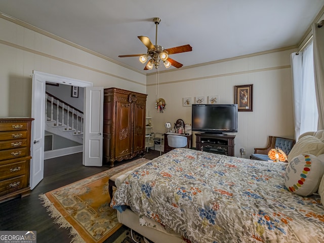 bedroom with a ceiling fan, dark wood-type flooring, and crown molding
