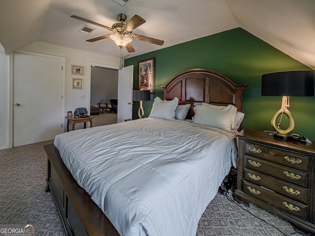 bedroom with vaulted ceiling, visible vents, carpet floors, and ceiling fan