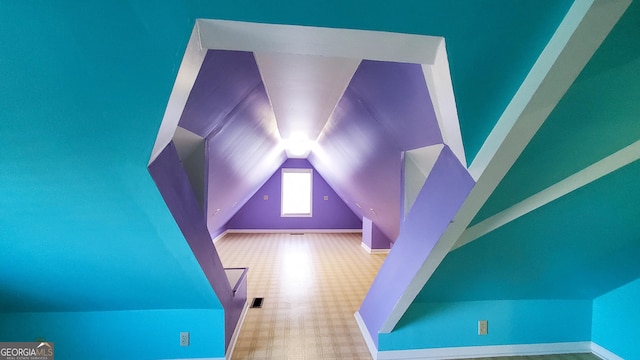 bonus room featuring lofted ceiling and visible vents
