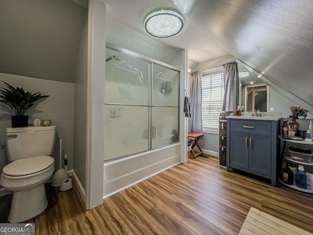 full bathroom with shower / bath combination with glass door, toilet, lofted ceiling, wood finished floors, and vanity