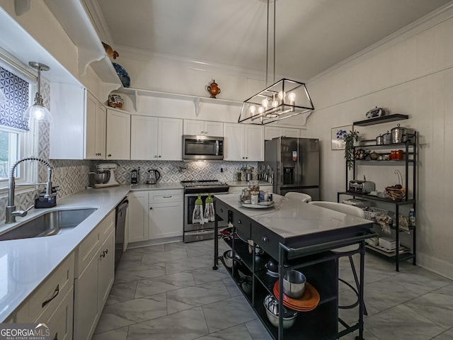 kitchen with stainless steel appliances, a sink, tasteful backsplash, a chandelier, and crown molding