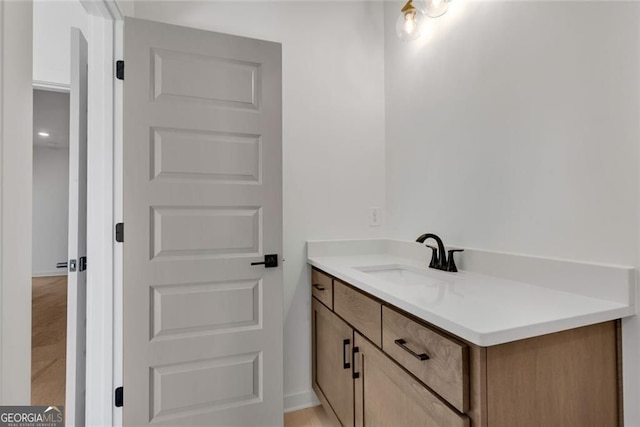 bathroom featuring baseboards and vanity