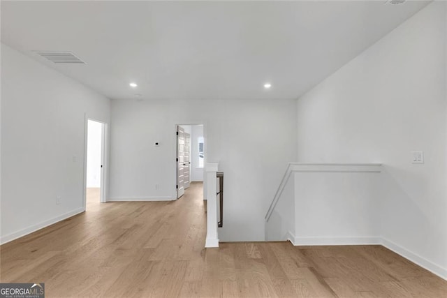 empty room with recessed lighting, visible vents, light wood finished floors, and baseboards