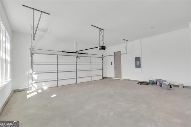 garage featuring a garage door opener and electric panel