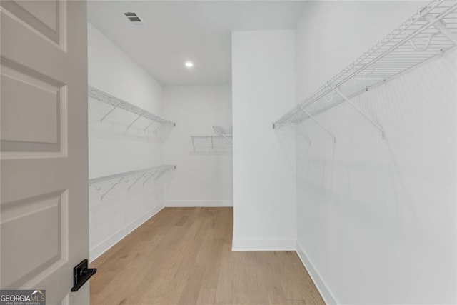 walk in closet with light wood-style flooring and visible vents