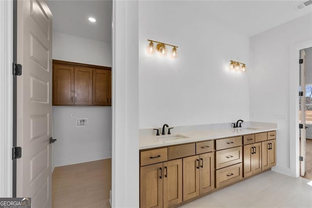full bath with double vanity, visible vents, tile patterned floors, and a sink