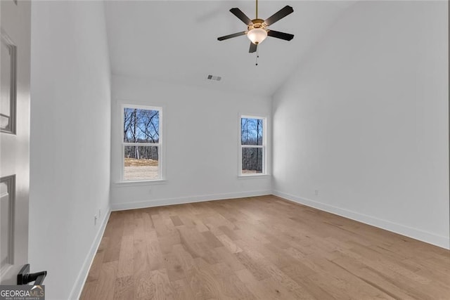 spare room with high vaulted ceiling, a ceiling fan, light wood-type flooring, baseboards, and visible vents