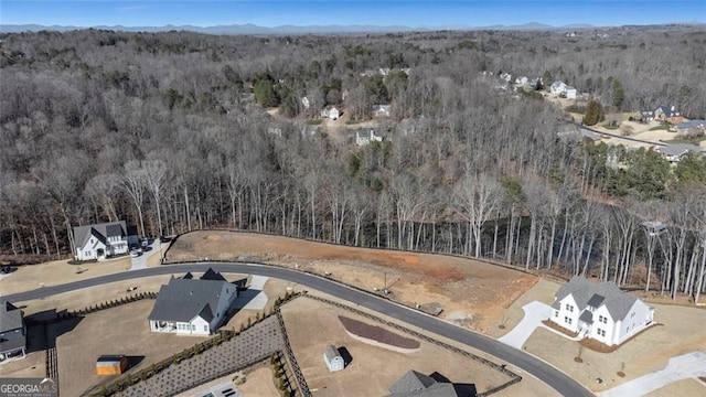 drone / aerial view with a forest view and a mountain view