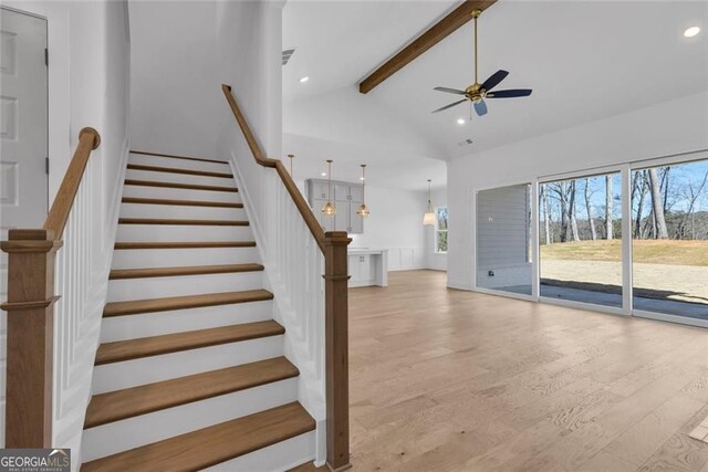 stairway featuring recessed lighting, beamed ceiling, wood finished floors, ceiling fan, and high vaulted ceiling