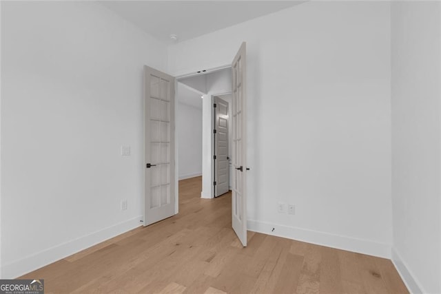 unfurnished bedroom featuring baseboards and light wood-style floors