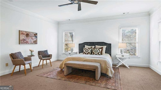 carpeted bedroom featuring ornamental molding, baseboards, and a ceiling fan
