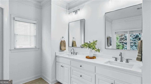 full bath featuring ornamental molding, double vanity, and baseboards