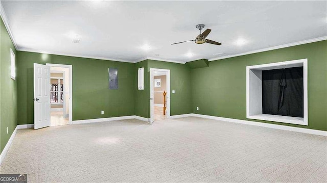 unfurnished room featuring ornamental molding, baseboards, a ceiling fan, and light carpet
