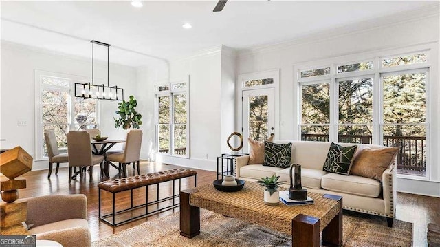 living room with crown molding, plenty of natural light, wood finished floors, and recessed lighting