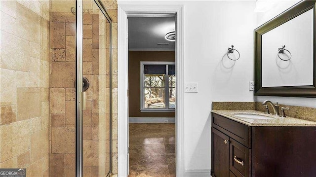 bathroom featuring a shower stall, vanity, ornamental molding, tile patterned flooring, and baseboards