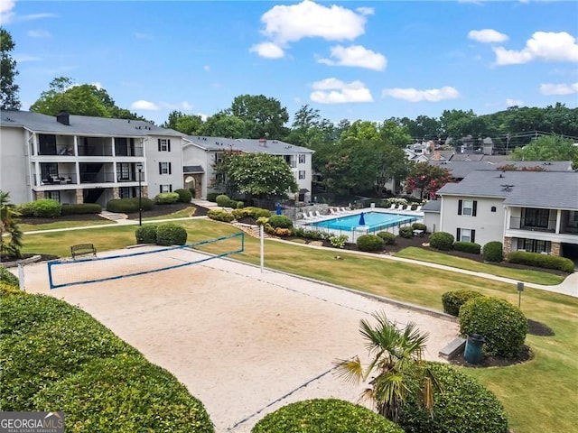 surrounding community featuring volleyball court and a yard