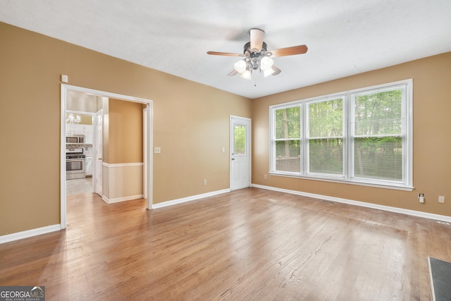 10044 Point View Dr, Jonesboro, GA 30238 - spare room with a ceiling fan, baseboards, and light wood finished floors