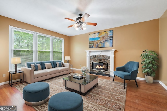 10044 Point View Dr, Jonesboro, GA 30238 - living room featuring baseboards, ceiling fan, wood finished floors, and a fireplace