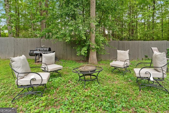 10044 Point View Dr, Jonesboro, GA 30238 - view of yard featuring a fenced backyard and an outdoor fire pit