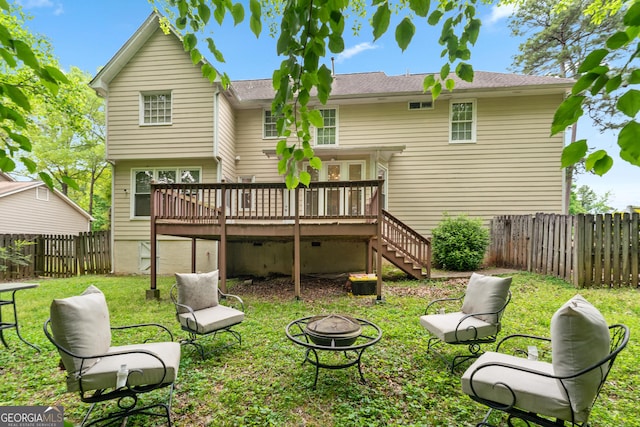 10044 Point View Dr, Jonesboro, GA 30238 - back of property with a fire pit, a wooden deck, a fenced backyard, a lawn, and stairway