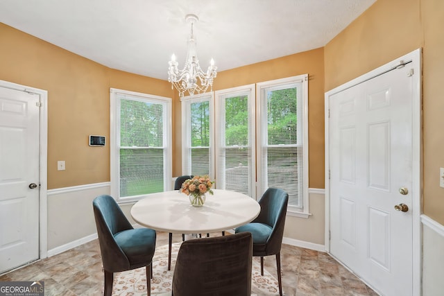 10044 Point View Dr, Jonesboro, GA 30238 - dining space with an inviting chandelier and baseboards
