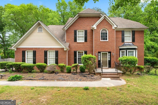 10044 Point View Dr, Jonesboro, GA 30238 - colonial home featuring brick siding, roof with shingles, and a front lawn