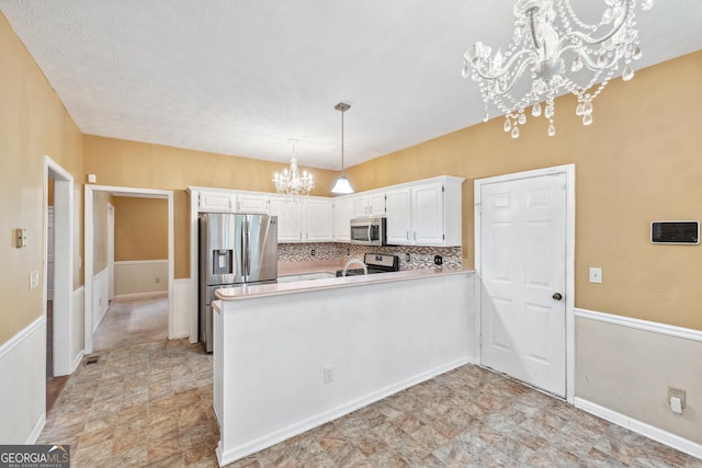 10044 Point View Dr, Jonesboro, GA 30238 - kitchen with appliances with stainless steel finishes, light countertops, white cabinets, a peninsula, and a notable chandelier