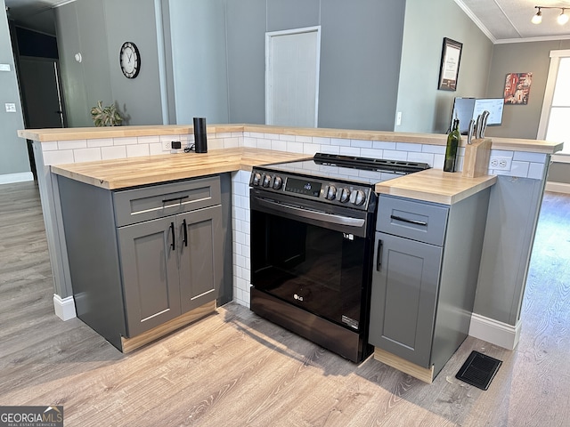 112 Little River Ct, Eatonton, GA 31024 - kitchen with light wood-style floors, gray cabinetry, stainless steel range with electric cooktop, and ornamental molding
