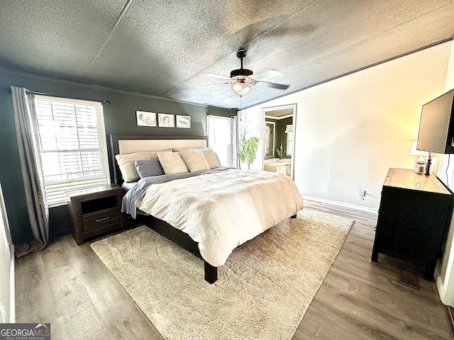 112 Little River Ct, Eatonton, GA 31024 - bedroom with a ceiling fan, light wood-style floors, a textured ceiling, and connected bathroom