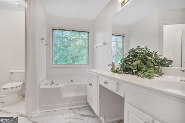 bathroom with a bath, marble finish floor, vanity, and toilet