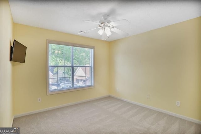 empty room with ceiling fan, baseboards, and carpet flooring
