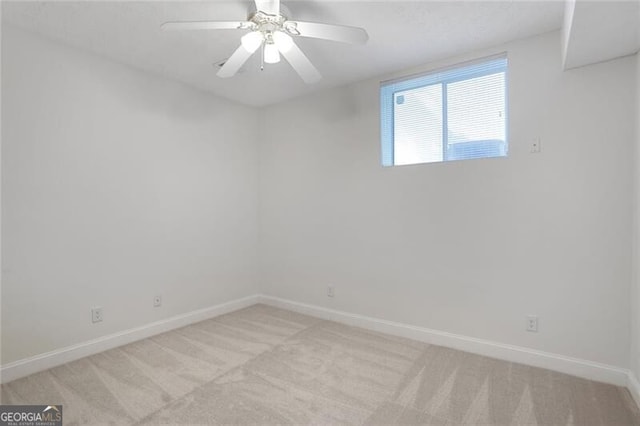 unfurnished room with light carpet, a ceiling fan, and baseboards