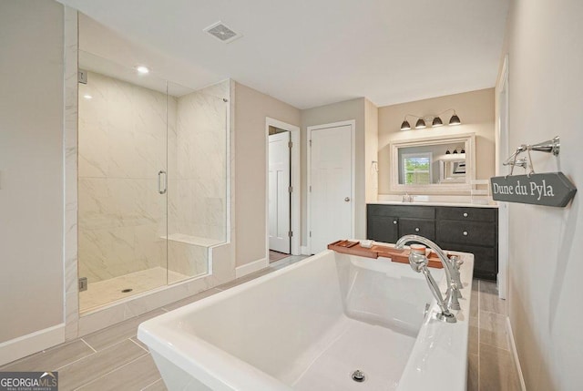 2127 Harmony Dr, Canton, GA 30115 - bathroom with a soaking tub, a stall shower, vanity, baseboards, and recessed lighting