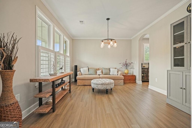 2127 Harmony Dr, Canton, GA 30115 - living area with ornamental molding, wood finished floors, arched walkways, baseboards, and a chandelier