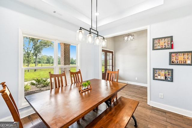 dining space with baseboards, visible vents, plenty of natural light, and wood finished floors