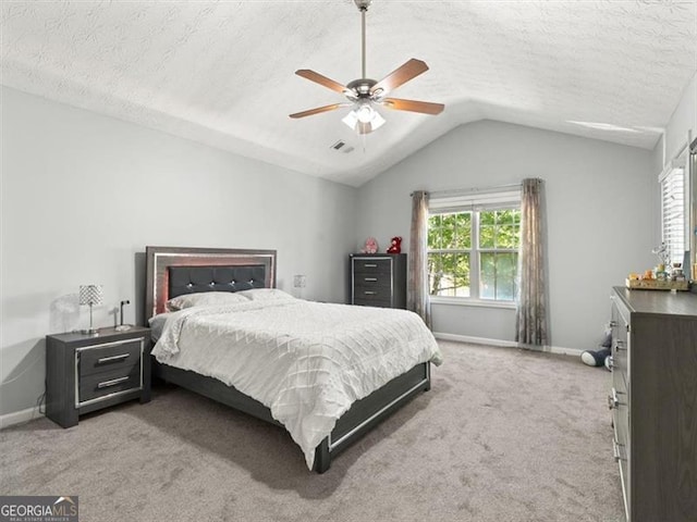 4643 Grand Central Pkwy, Decatur, GA 30035 - carpeted bedroom featuring vaulted ceiling, baseboards, a textured ceiling, and ceiling fan