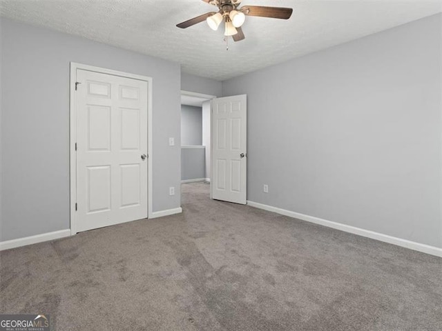 4643 Grand Central Pkwy, Decatur, GA 30035 - unfurnished bedroom featuring carpet flooring, baseboards, a textured ceiling, and ceiling fan