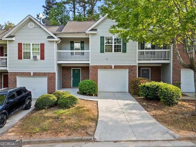 4643 Grand Central Pkwy, Decatur, GA 30035 - multi unit property featuring an attached garage, driveway, brick siding, and a balcony