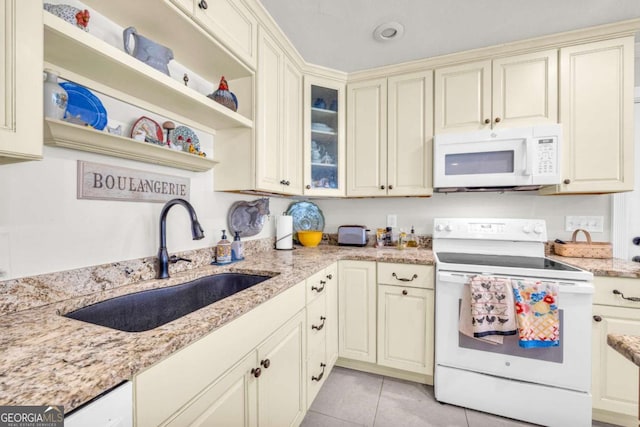 84 Weatherly Rd, Clarkesville, GA 30523 - kitchen featuring cream cabinetry, light tile patterned floors, a sink, white appliances, and light stone countertops