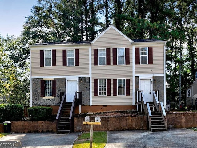 townhome / multi-family property with crawl space and stone siding