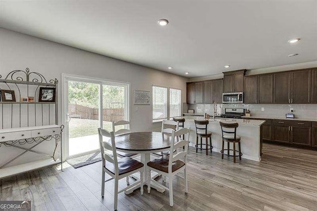 dining space featuring recessed lighting and wood finished floors