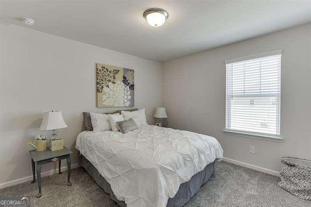 carpeted bedroom featuring baseboards