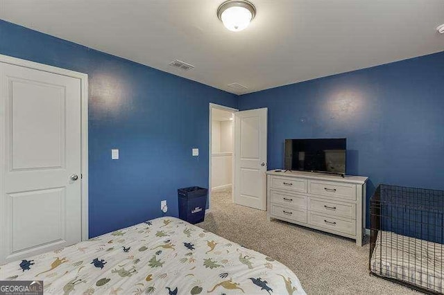 bedroom with visible vents, baseboards, and light carpet