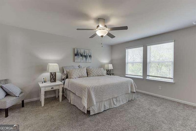 bedroom featuring ceiling fan, baseboards, and light carpet