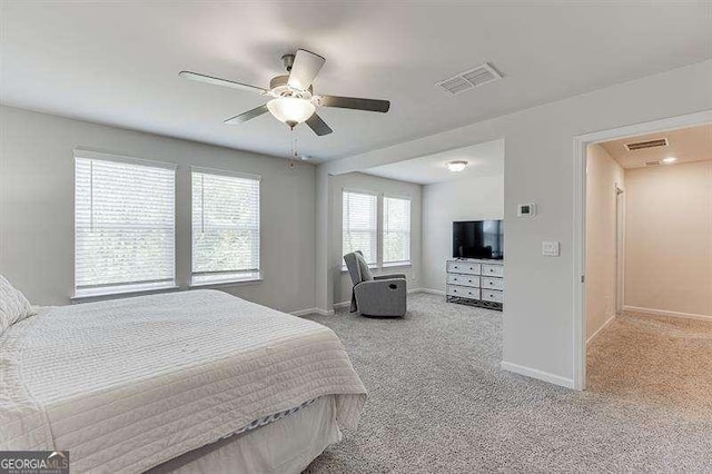 carpeted bedroom featuring visible vents, baseboards, and ceiling fan