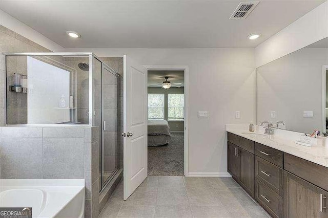 bathroom with a garden tub, a ceiling fan, a stall shower, double vanity, and visible vents