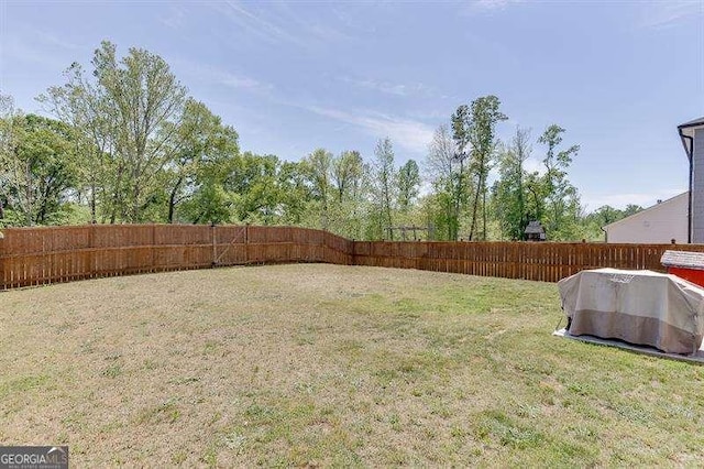 view of yard with a fenced backyard
