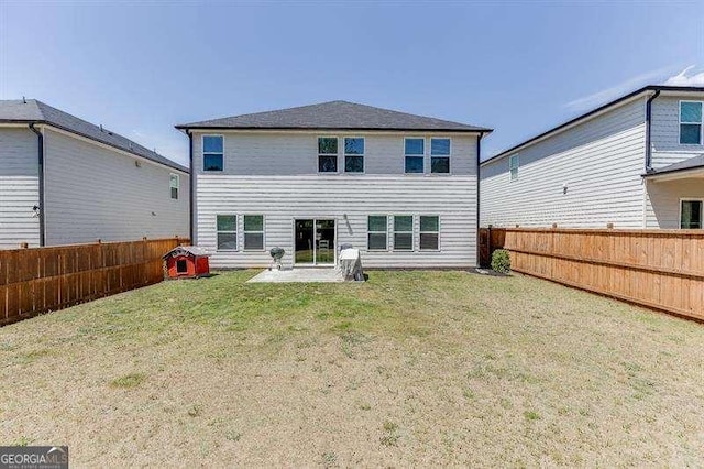 back of property featuring a lawn and a fenced backyard
