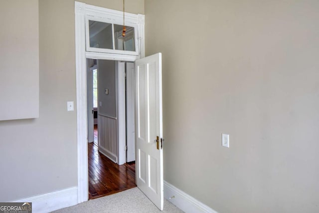interior space with carpet flooring and baseboards
