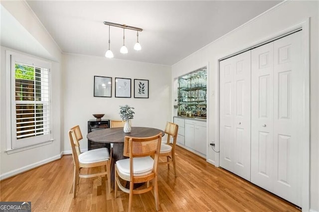 1420 Defoors Dr NW, Atlanta, GA 30318 - dining room with track lighting, light wood-style floors, and ornamental molding